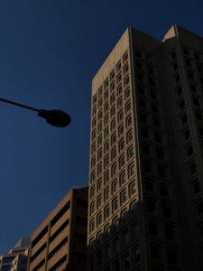 black street light near white concrete building during daytime