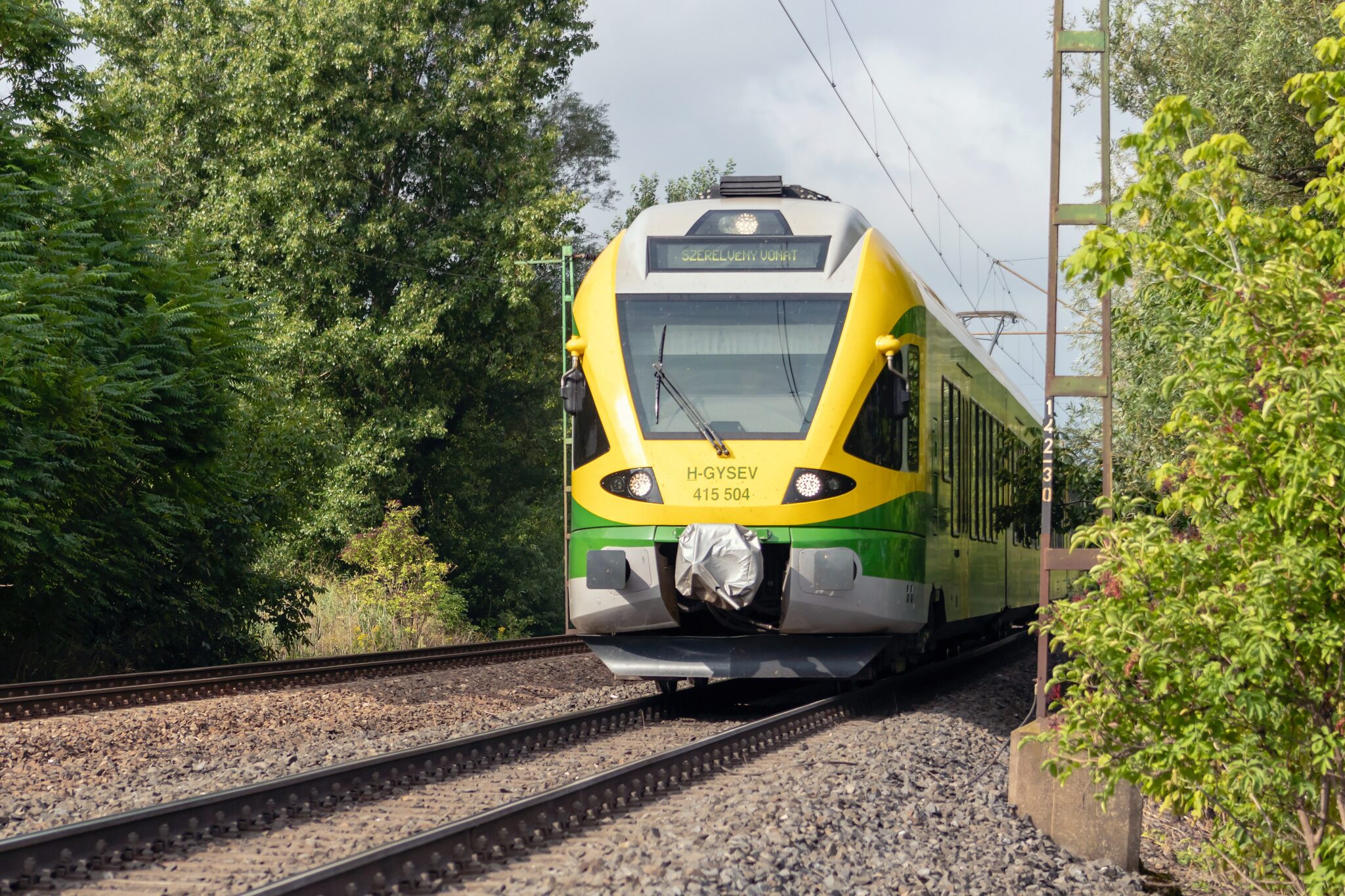 yellow and gray train on rail tracks