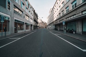 empty road between high rise buildings during daytime