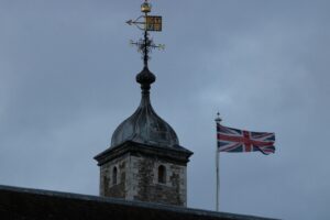 a tower with a clock and a flag on top of it