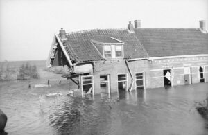 a black and white photo of a flooded house