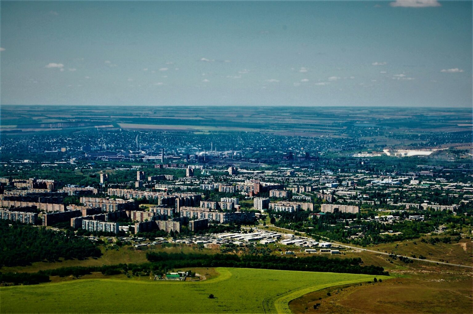 a city with a body of water in the background