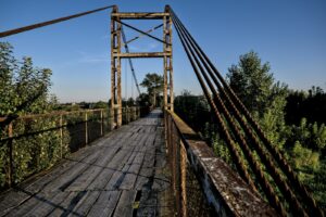 brown wooden bridge under blue sky during daytime