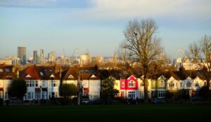 A row of houses with a city in the background