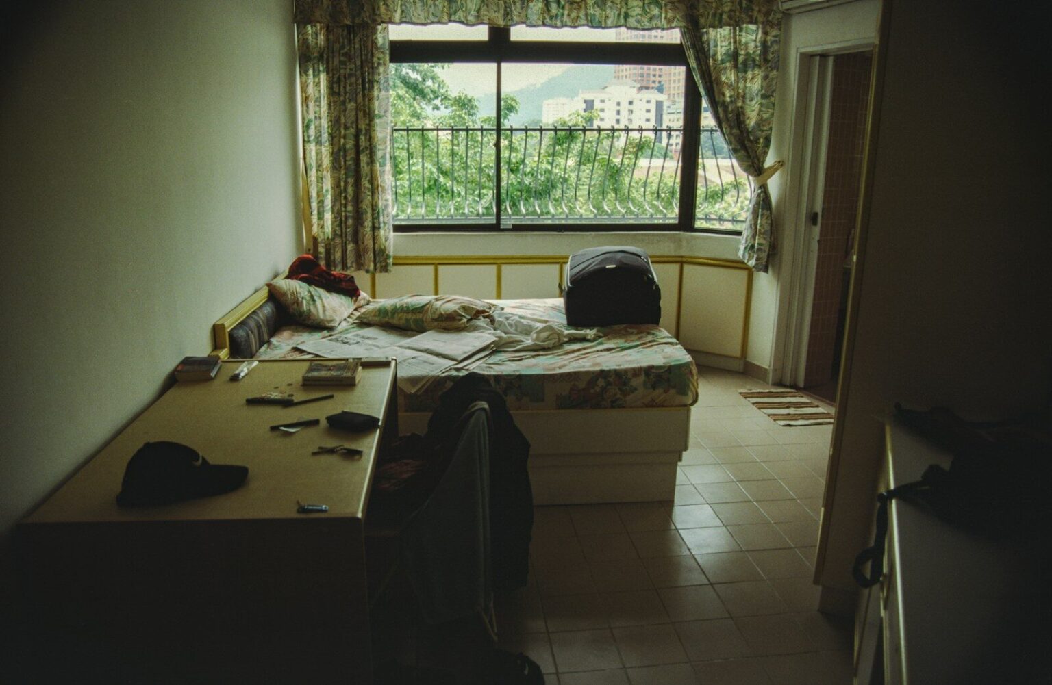 A bedroom with a bed and a window