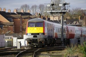 a yellow and red train traveling down train tracks