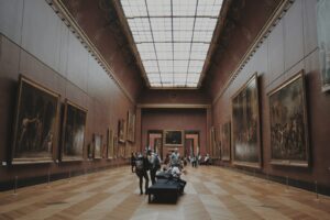 people walking on corridor looking at painting
